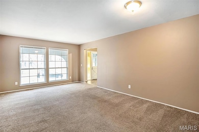 Spare room with carpet floors and baseboards