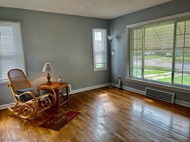 Living area with dark hardwood flooring and a textured ceiling