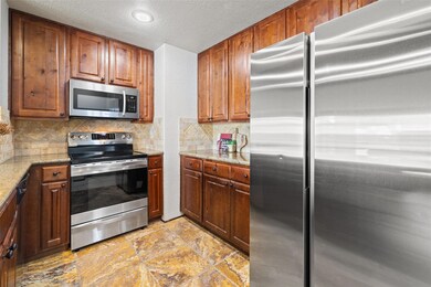 Kitchen with stainless steel appliances, light st