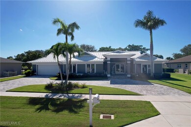 Ranch-style home featuring metal roof, a garage, f