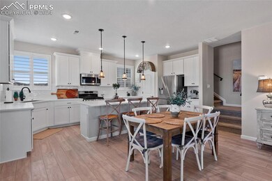 Dining space featuring sink and light wood-type flooring