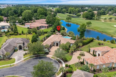 Aerial perspective of suburban area with a large body of water and a local golf course