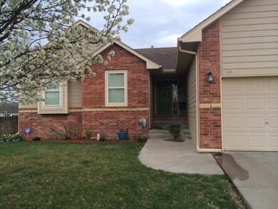 Nicely maintained front yard with flowering tree