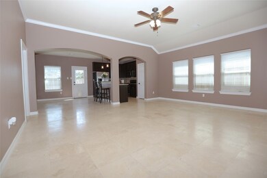 Oversized neutral tile floors flow through the home, except in the bedrooms.  This is the main living area, open to the kitchen/breakfast room.