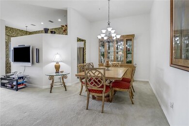Carpeted dining area with a chandelier