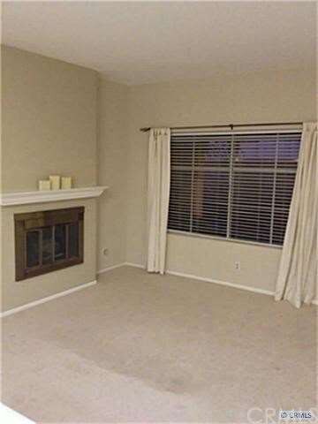 Light and Bright living room with large window ove