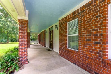 Huge & inviting, this covered front porch measures at 46x9. Blue porch ceilings are rooted in Southern tradition & add visual interest to an outdoor space, as seen here. There is plenty of space for porch swings and/or rockers to enjoy the outdoors.