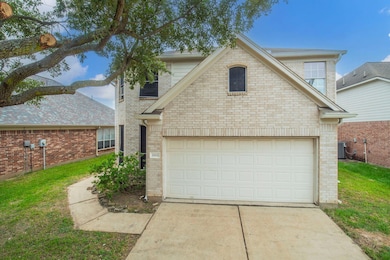 Traditional-style home featuring driveway, brick 