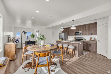Dining area with recessed lighting and light wood-style flooring