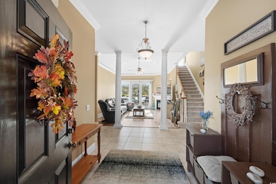 Foyer featuring light tile patterned floors, decor