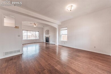 Unfurnished living room featuring hardwood / wood-style floors, visible vents, and a healthy amount of sunlight