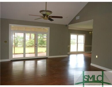 Living Room. Looking out on screened porch and int