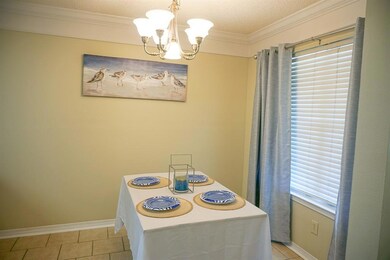 Dining room featuring a chandelier, light tile pat