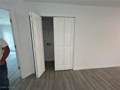 Unfurnished bedroom with wood finish floors and a