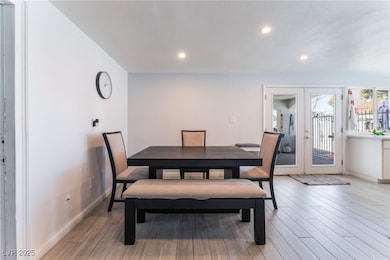 Dining room with french doors, light wood-style fl