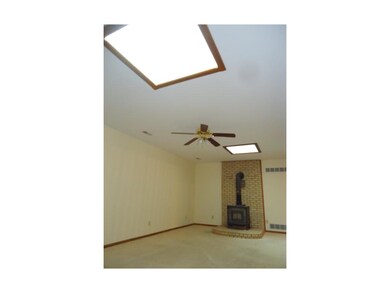 Living room w/wood stove and skylight