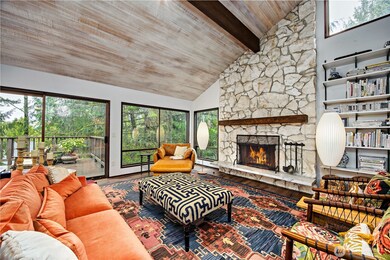 Cozy fireplace, vaulted ceilings and lots of light make this a lovely living space.