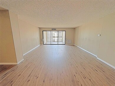 Large open living and dining area and an enclosed porch overlooing the water