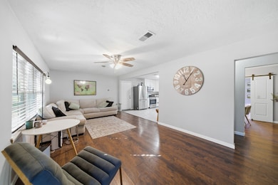 The living room opens to the kitchen area and neutral toned walls compliment the space!
