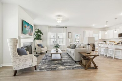 Living room featuring ceiling fan and light hardwo