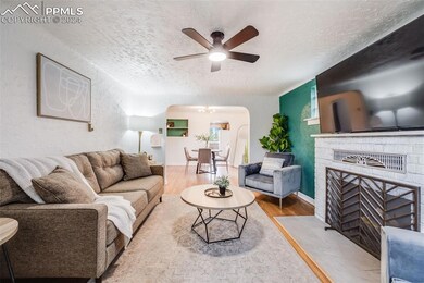 Living room with a textured ceiling, ceiling fan, 