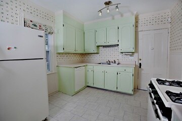 Kitchen. door leads to back foyer, backyard, and b