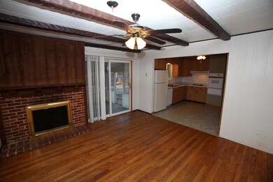 Hearth room off kitchen with wood floors