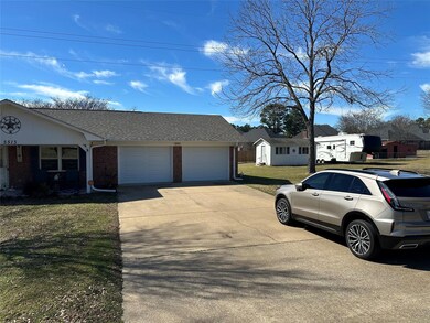 View of front facade featuring a garage, driveway,
