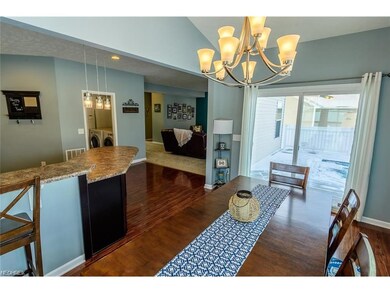 THE DINING ROOM IS BRIGHT AND LEADS OUT TO THE LAR