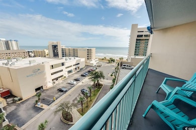 Balcony featuring a water view and a beach view