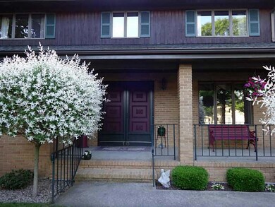 Exterior Front. welcoming brick front porch with d