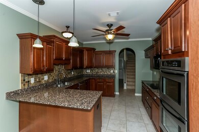 You'll love entertaining in this fabulous kitchen! Stainless steel appliances, brand new (never used) smooth cooktop, double oven, microwave, tile floors, granite tops, tumble marble backsplash, cherry stained cabinetry!