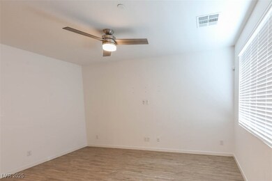 Empty room featuring baseboards, light wood-type f