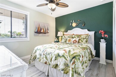 Bedroom with ceiling fan and hardwood / wood-style