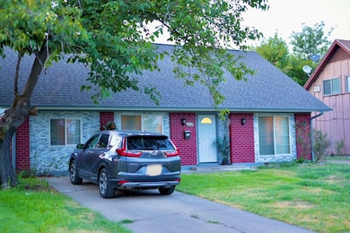 View of front of property with brick siding, roof 
