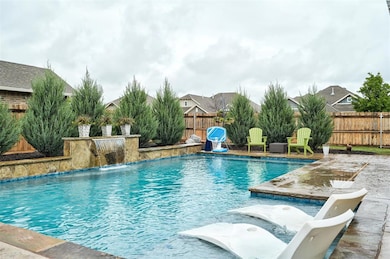View of pool with a fenced backyard
