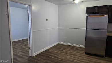 Kitchen with freestanding refrigerator, baseboards