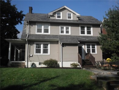 View of the back of the home with slate patio and 