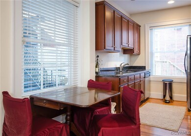The KITCHEN has hardwood floors, granite countertops, cherry cabinetry, and stainless steel appliances.