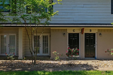 Property entrance featuring french doors and brick