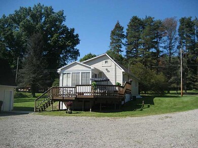 The enclosed porch with walkout to deck overlooks 