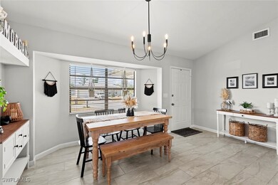 Dining room with vaulted ceiling and a notable cha