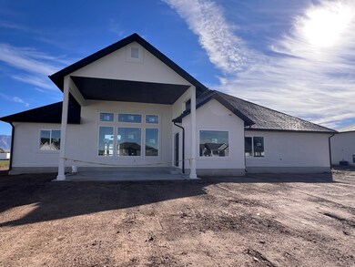 Rear view of property featuring stucco siding and a patio area