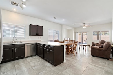 Kitchen featuring visible vents, a peninsula, ligh