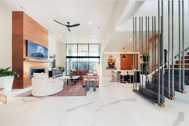Tiled living room featuring floor to ceiling windo