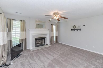 Family room with gas log fireplace is at the other