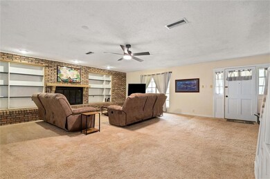 Living room featuring  built in shelves and a fire