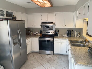 The updated kitchen offers views of the living are