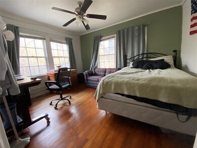 Bedroom with ceiling fan, wood finished floors, a