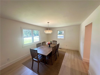 Dining area featuring a chandelier and light wood-type flooring